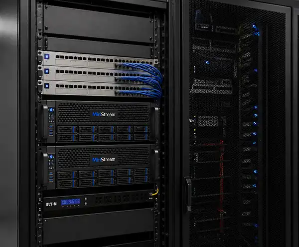 Two Miristream rackmount servers installed in a data centre cabinet, with networking switches above and Eaton power management below